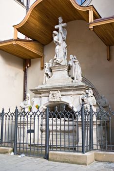 statuary angel with a cross under a canopy