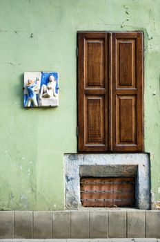 Old small door in the stone wall. 