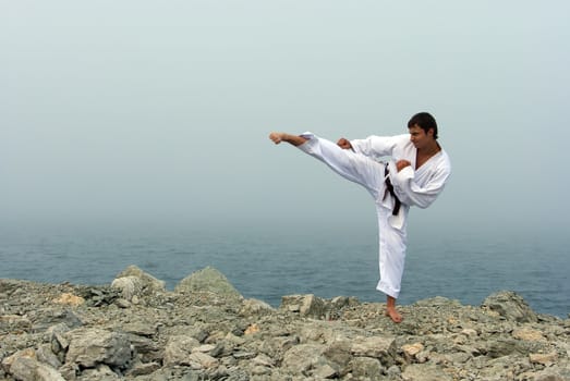 karate trains on the shores of the misty sea