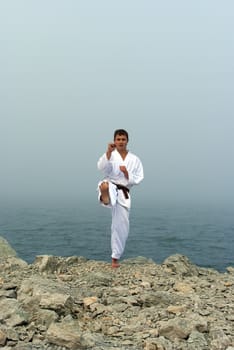 karate trains on the shores of the misty sea
