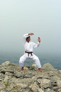 karate trains on the shores of the misty sea