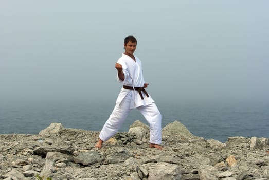 karate trains on the shores of the misty sea