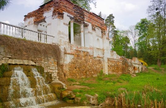 old gazebo with a waterfall in the park