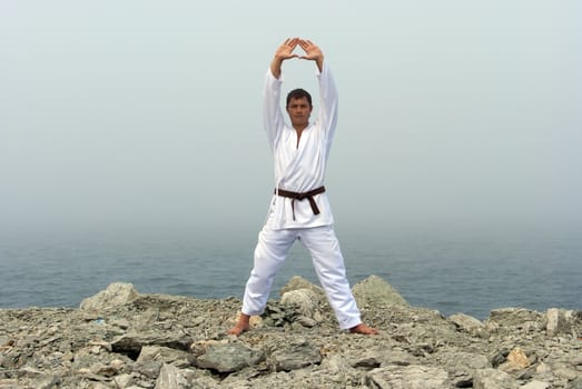 karate trains on the shores of the misty sea