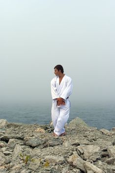 karate trains on the shores of the misty sea