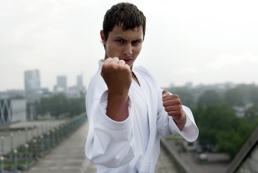 karate poses against the backdrop of the city
