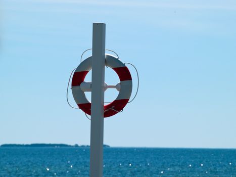 Life buoy / Life Preserver / Life ring / Life belt with clear blue sea ocean background
