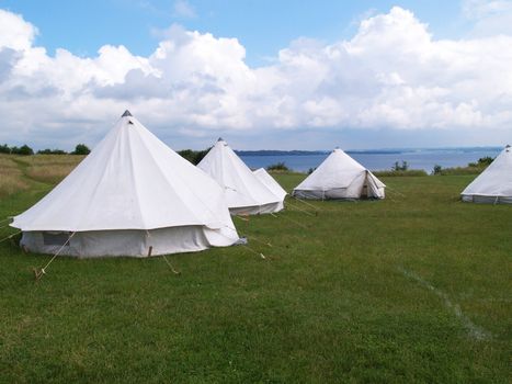 Classical traditional tents in a camping nature site by the beach ocean