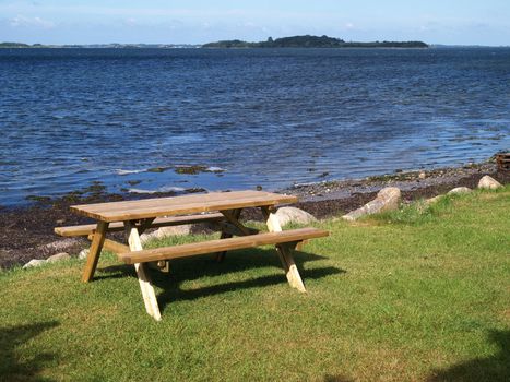 Outdoors Picnic table by the beach with sea ocean background