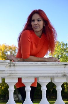 Redhead girl standing at the railing
