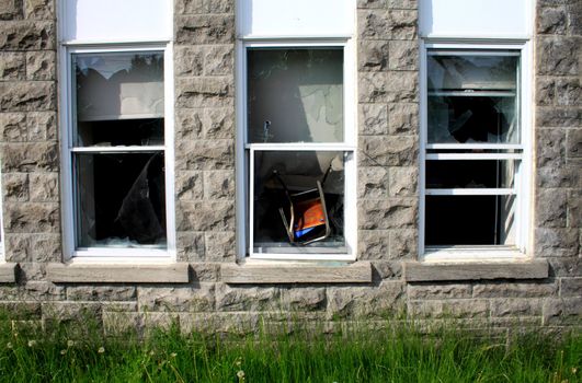 Chair thrown in window by vandals on historic building