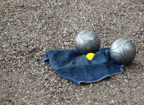 Ball French game petanque with two balls and a towel on the ground