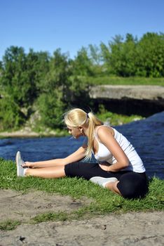 girl doing exercise near a waterfall