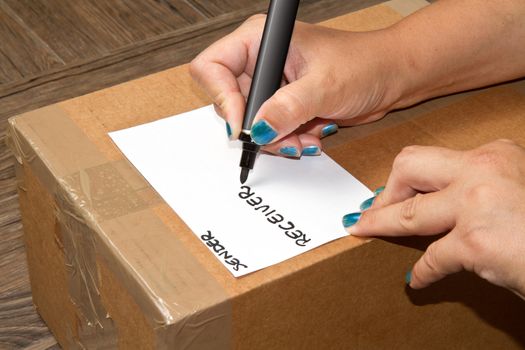pen on cardboard box with handle