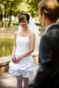 Happy young bride looks at the lovely bride