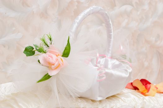 Small pretty basket decorated by tapes and an artificial flower