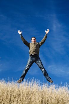 happy man jumping over the field