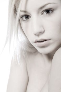 Studio portrait of a young blond woman wondering