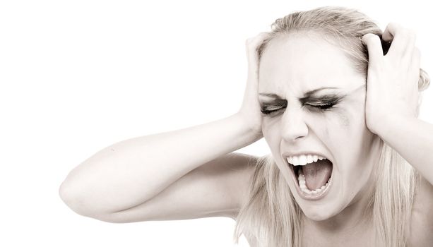 Studio portrait of a young blond woman in despair