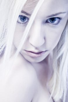 Studio portrait of a young blond woman in blue