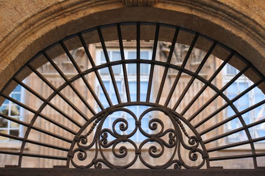 Ancient stylish iron ornament above an house's door