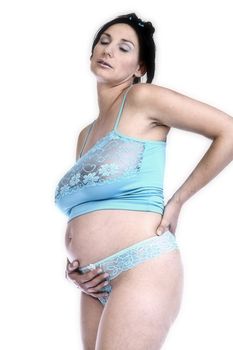 Studio portrait of a mature pregnant woman with back pain