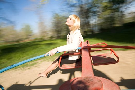 young girl goes for drive on roundabout