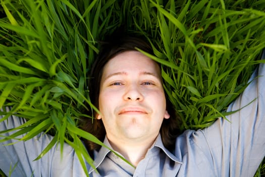 businessman rest on the green grass