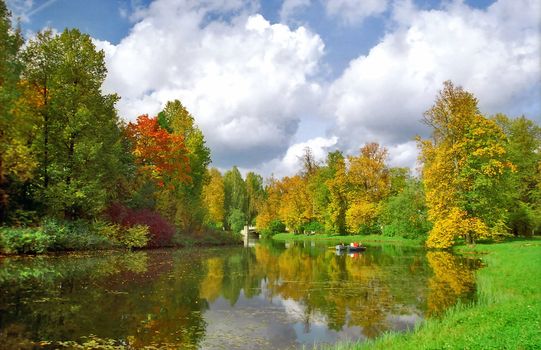 Picturesque autumn pond and two boats