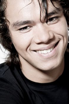 Studio portrait of a muscular Asian sexy looking boy smiling