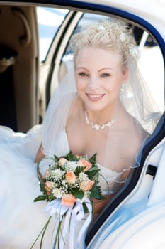 Portrait of the bride sitting in the car