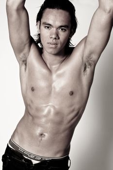 Studio portrait of a muscular Asian sexy looking boy 