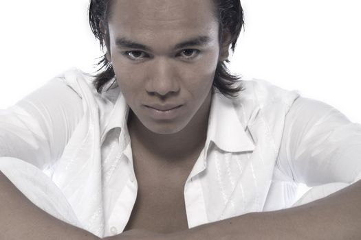 Studio portrait of a muscular Asian sexy looking boy looking hypnotising