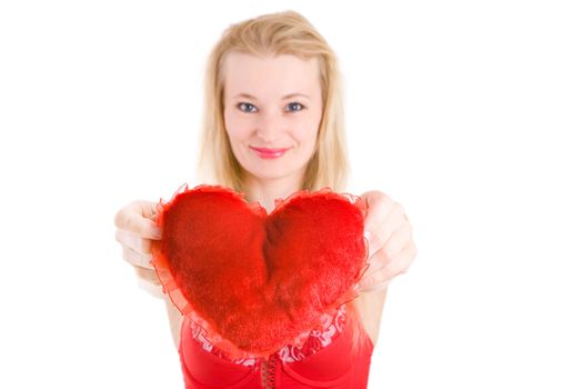 red pillow heart in the hands of the blond girl