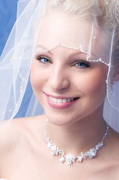 smiling bride under a veil