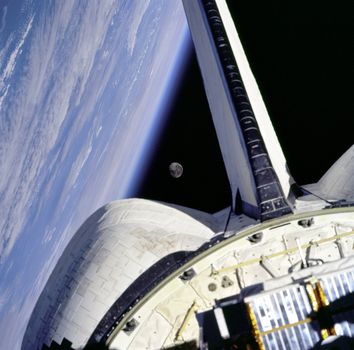 The moon is framed between the Orbiter's OMS pod and the Earth limb over the Atlantic Ocean as seen from the aft windows onboard Discovery on mission STS-95. ** Credit: NASA / yaymicro.com **