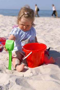 baby girl on the beach and blue sky