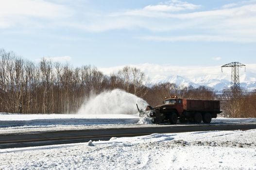 Snowplow removing snow from intercity snow road