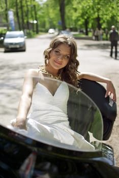 beautiful young bride sitting on a motorcycle