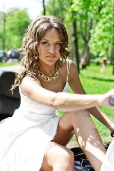 beautiful young bride sitting on a motorcycle