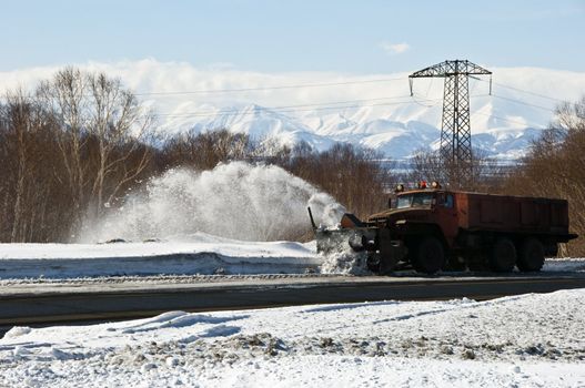 Snowplow removing snow from intercity snow road