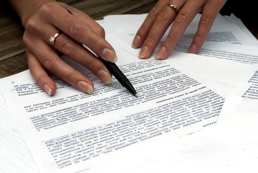 Close-up of female hands working with documents