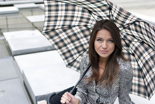 portrait of a beautiful girl with an umbrella on background