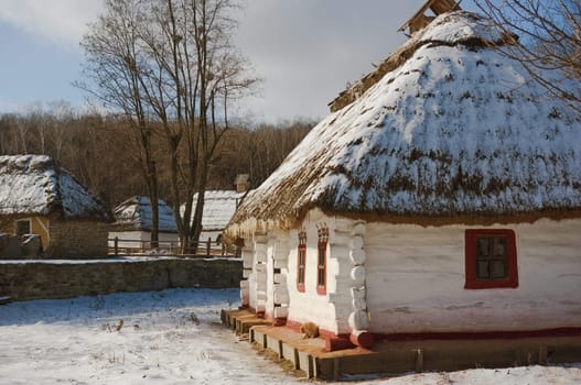 old rural whitewashed house with a thatched roof
