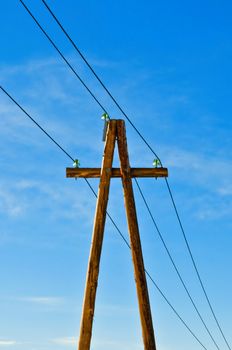 Electric column with wires against the dark blue sky