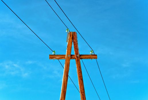 Electric column with wires against the dark blue sky