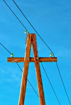 Electric column with wires against the dark blue sky