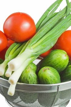 cucumbers and red tomatoes lie in basket