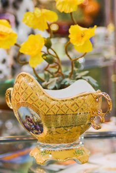Old kitsch vase with floral pattern and gilded details