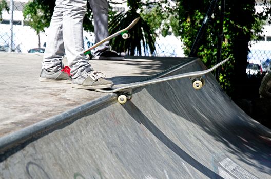 Skateboarders ready to drop in on a ramp